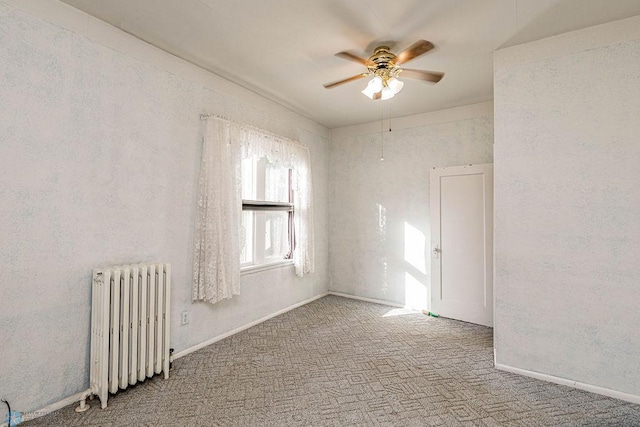 carpeted spare room featuring ceiling fan and radiator heating unit