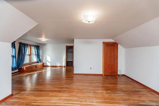 bonus room with lofted ceiling and light hardwood / wood-style floors