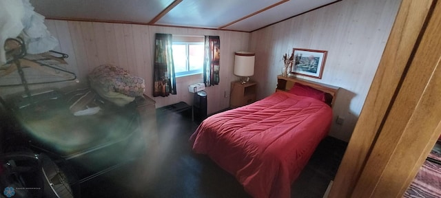 bedroom featuring wood walls and vaulted ceiling