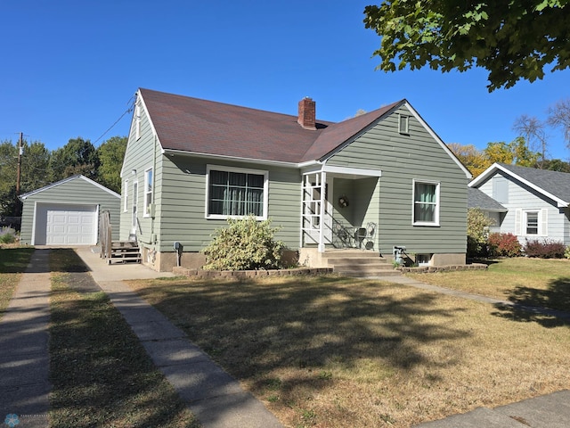 bungalow with an outdoor structure, a front yard, and a garage