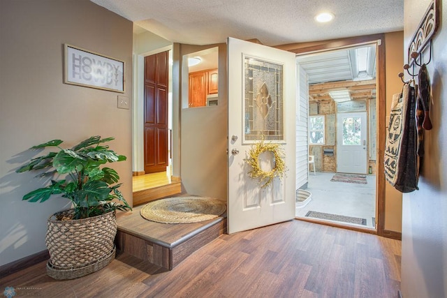 entryway with hardwood / wood-style flooring and a textured ceiling