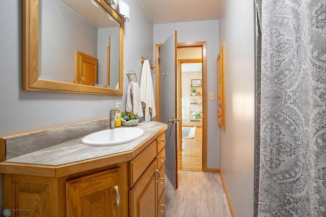 bathroom with vanity and hardwood / wood-style flooring