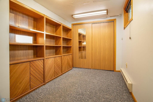 hallway with carpet floors and a baseboard radiator