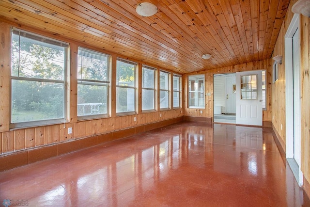 unfurnished sunroom featuring plenty of natural light and wooden ceiling