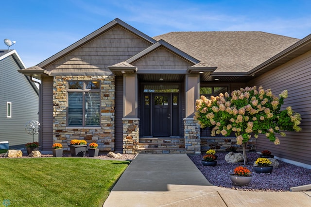 view of exterior entry featuring a yard