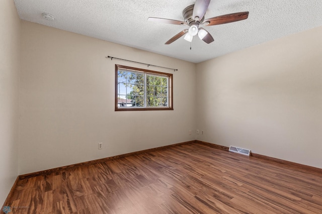 spare room with wood-type flooring, ceiling fan, and a textured ceiling