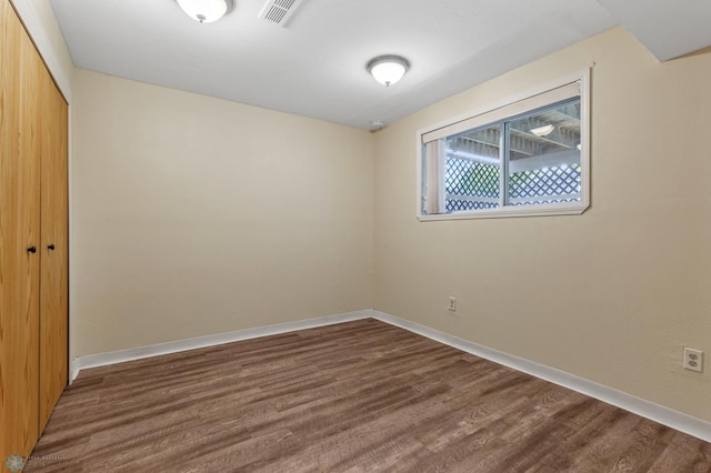 spare room featuring dark hardwood / wood-style flooring