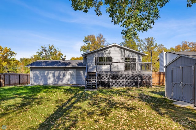 rear view of property with a yard, a deck, and a storage unit