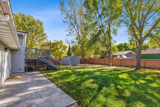 view of yard featuring a deck and a shed