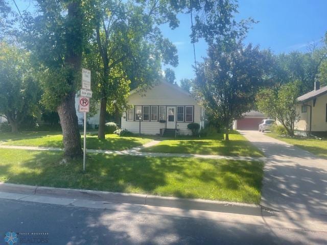 view of front of property with a garage and a front yard