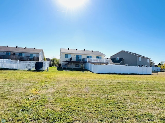 rear view of property with a lawn