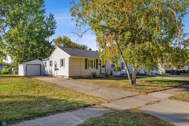 view of front of property with a front lawn, an outdoor structure, and a garage