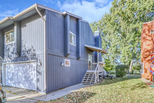 view of property exterior with a yard and a garage