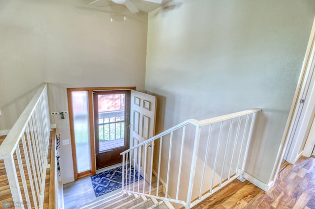 foyer entrance with ceiling fan and light hardwood / wood-style flooring