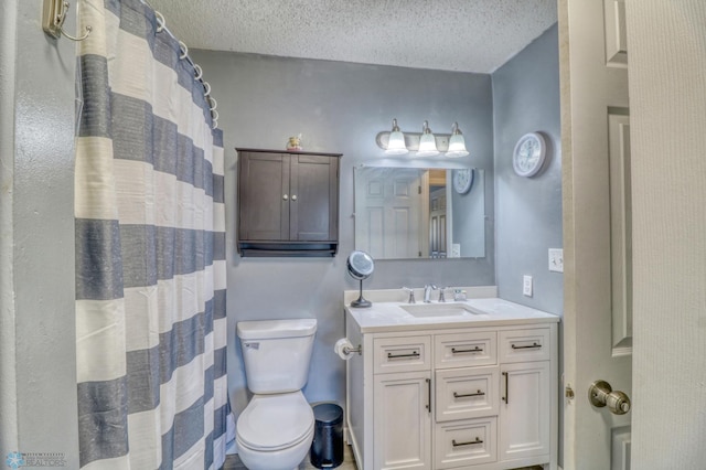 bathroom with vanity, toilet, a textured ceiling, and a shower with shower curtain