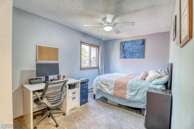 carpeted bedroom featuring a baseboard heating unit, a textured ceiling, and ceiling fan