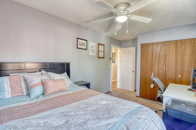 bedroom with a textured ceiling, ceiling fan, a closet, and light colored carpet