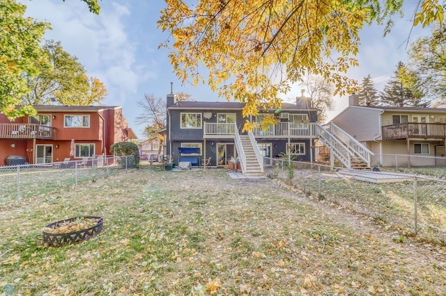 back of house featuring a yard and a deck