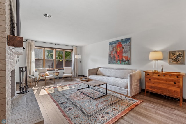 living room featuring a fireplace and wood-type flooring