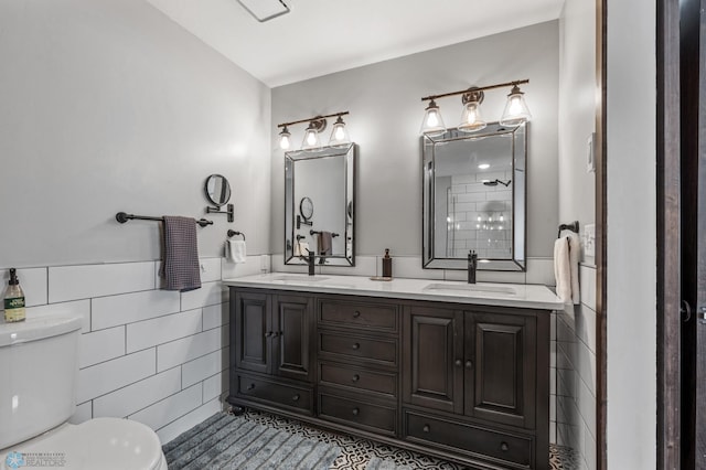 bathroom with vanity, tile walls, tile patterned flooring, and toilet