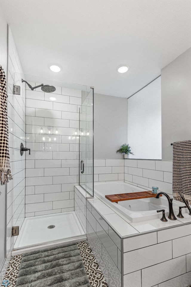 bathroom featuring tile patterned floors and independent shower and bath