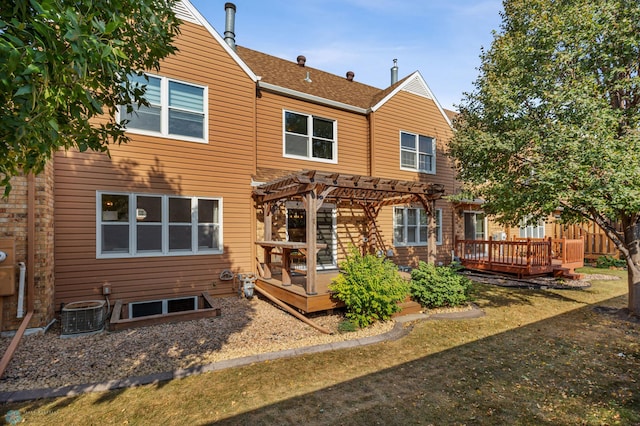 rear view of property with a pergola and a deck