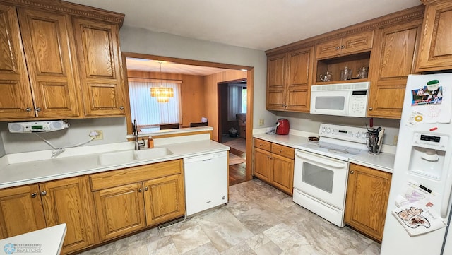 kitchen with a chandelier, sink, decorative light fixtures, and white appliances