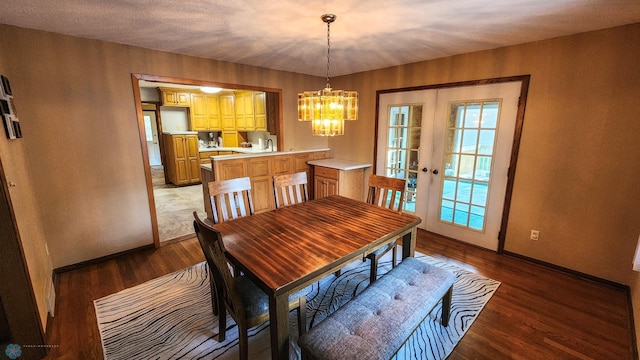 dining space with sink, french doors, a notable chandelier, and light hardwood / wood-style floors