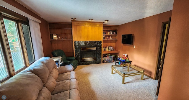 living room with a high end fireplace, a textured ceiling, and carpet floors