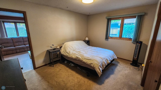 carpeted bedroom featuring a textured ceiling