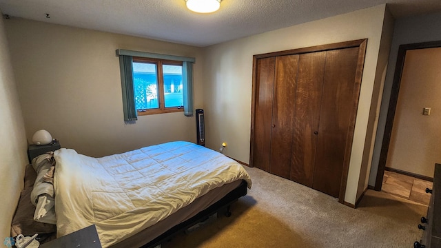 bedroom featuring a closet, a textured ceiling, and carpet flooring