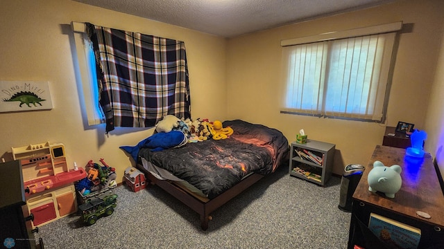 carpeted bedroom featuring a textured ceiling