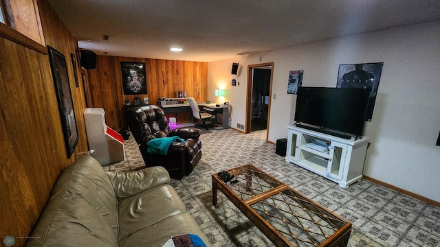 living room with a textured ceiling and wooden walls