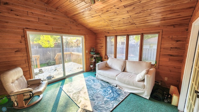 carpeted living room with lofted ceiling, wood ceiling, and wood walls