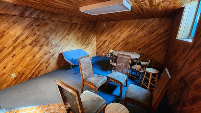 unfurnished room featuring wooden walls, bar area, and wooden ceiling