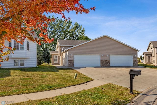 view of front of property featuring a garage and a front yard