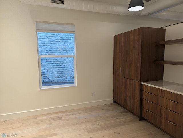 unfurnished bedroom with light wood-type flooring