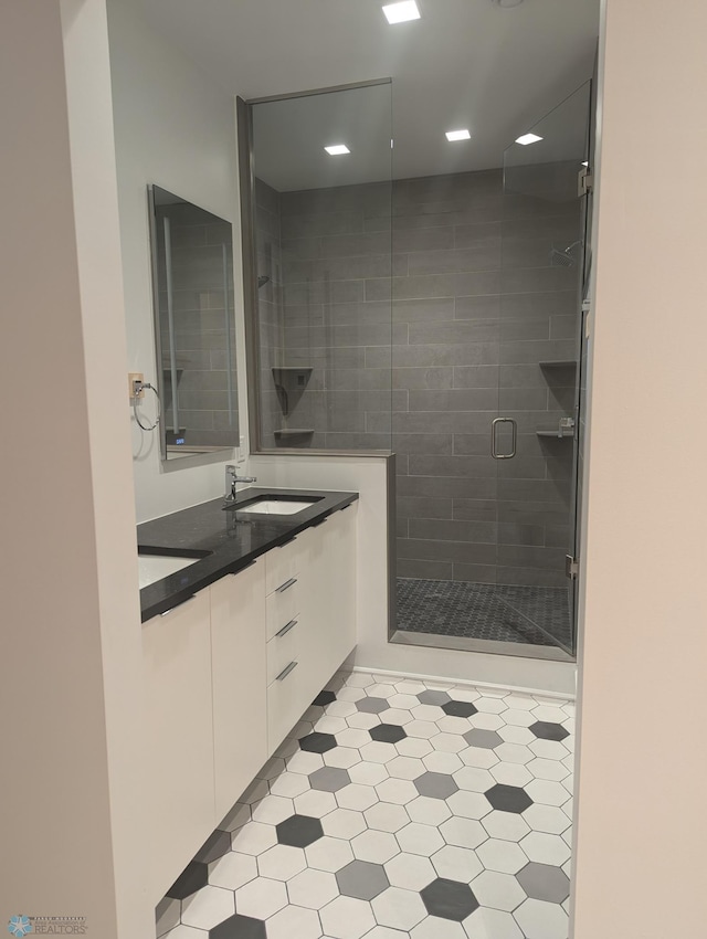 bathroom featuring an enclosed shower and vanity