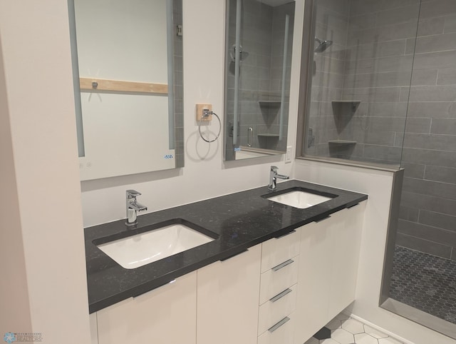 bathroom with vanity, tile patterned flooring, and tiled shower