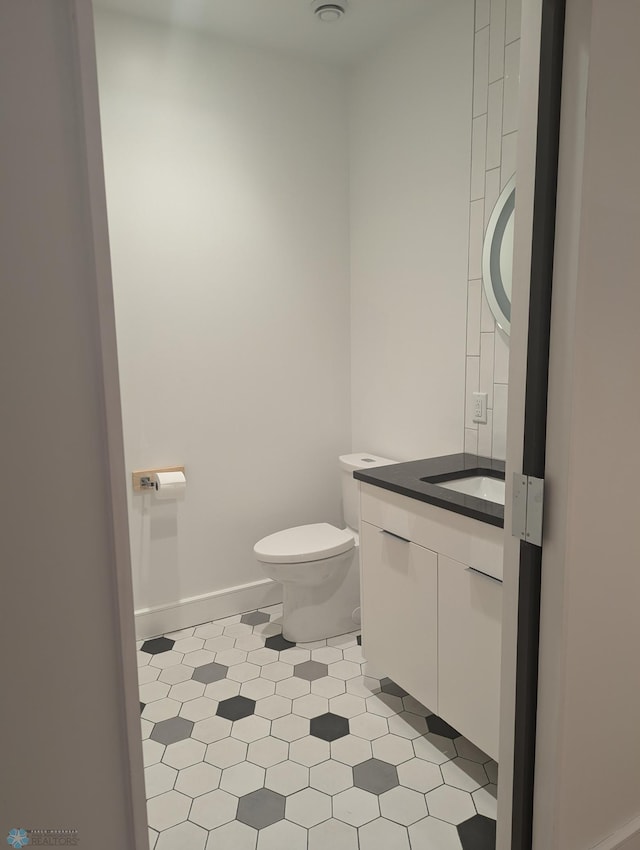 bathroom featuring vanity and toilet