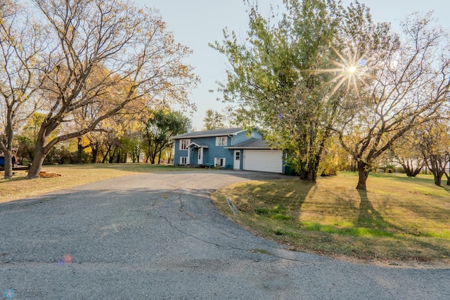 view of front facade with a front yard and a garage