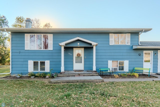 bi-level home with a front lawn