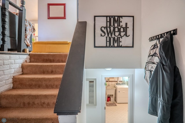 staircase featuring washer / clothes dryer and carpet flooring