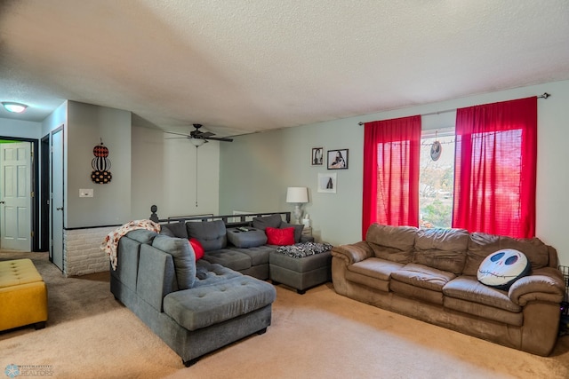 living room with ceiling fan, a textured ceiling, and carpet