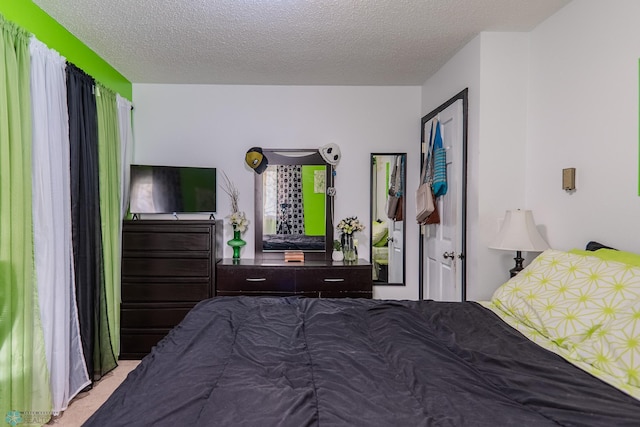 carpeted bedroom with a textured ceiling