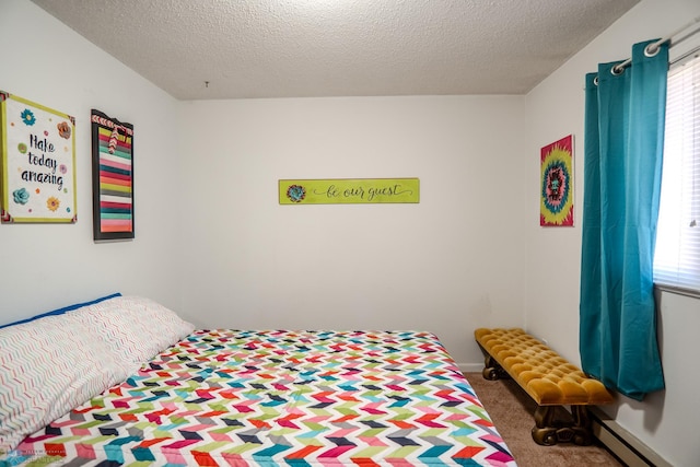 carpeted bedroom featuring a textured ceiling and baseboard heating