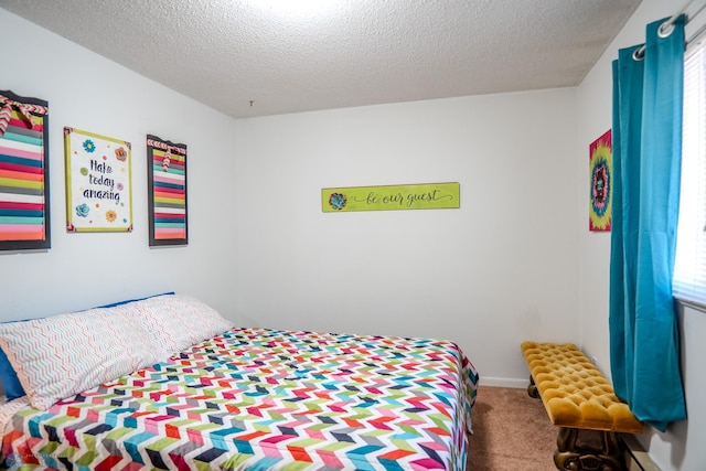 carpeted bedroom with a textured ceiling and multiple windows