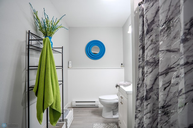 bathroom featuring vanity, hardwood / wood-style floors, a baseboard heating unit, walk in shower, and toilet