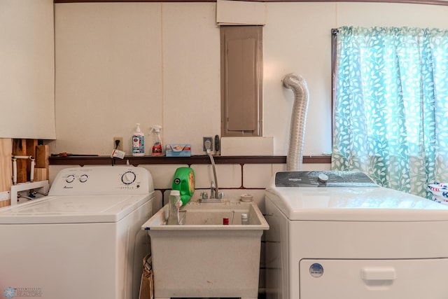 laundry area featuring independent washer and dryer and sink