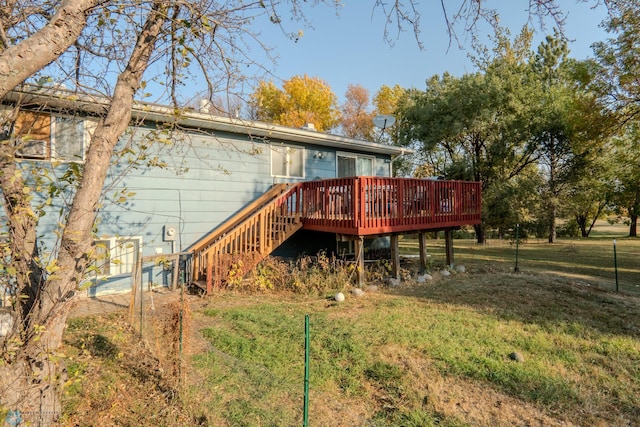 rear view of property with a yard and a deck